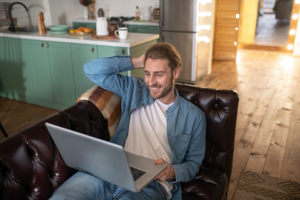 Smiling man staying at home while working remotely